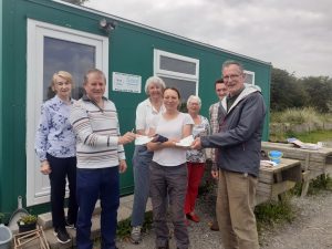 Members of Lecale Conservation presntenting cheques to Debbie Gillis of True Harvest Seeds to fund the gathering of seeds and propagation of plants.